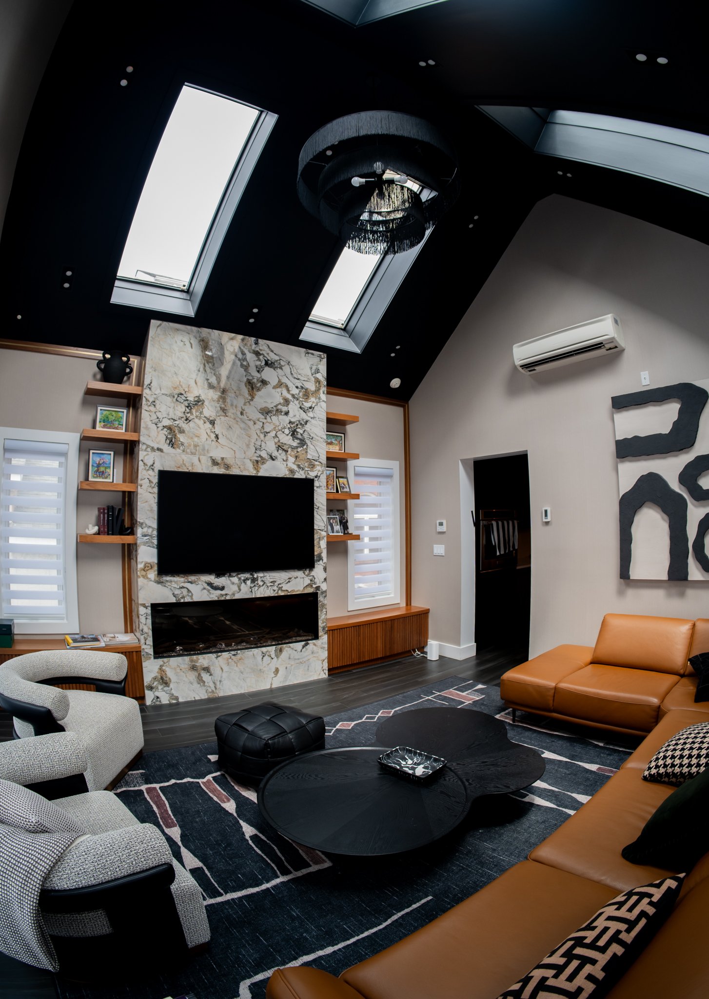 The grand living room beneath a vaulted skylight ceiling